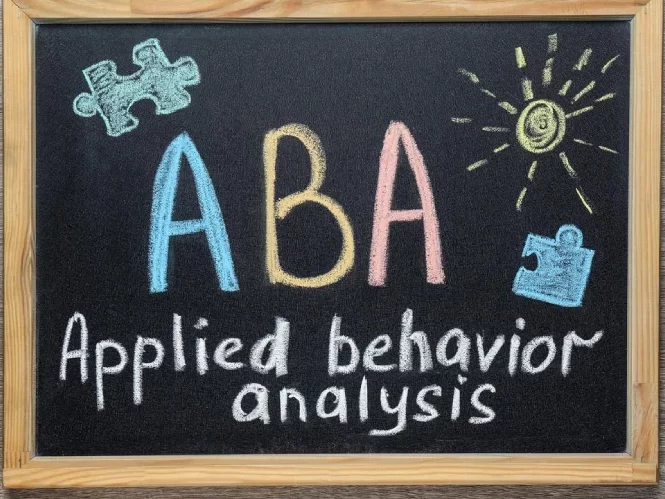 ABA applied behaviour analysis artwork on a black board