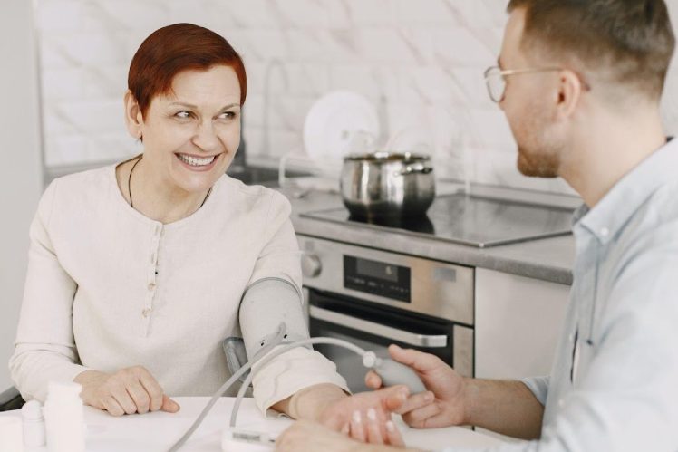home-nursing-care-eqc lady smiling at the doctors while getting checked at home