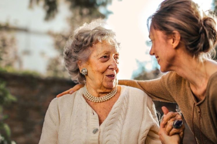 senior-safety-eqc Old lady talking to Home care nurse