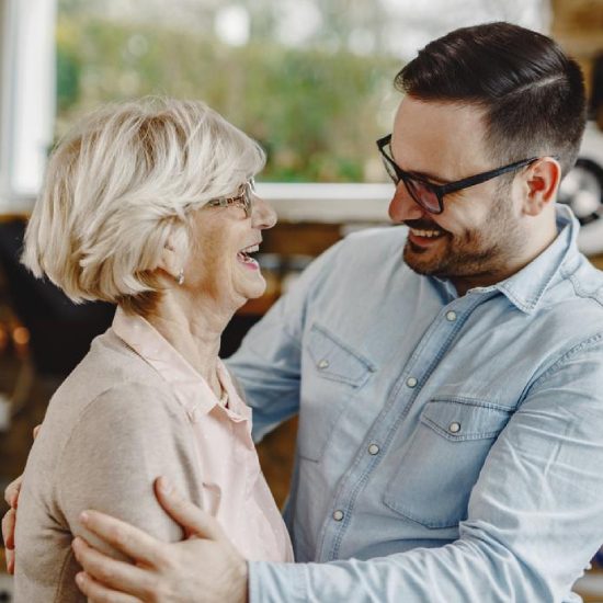 Old lady laughing while having a pleasant conversation with Home care guy