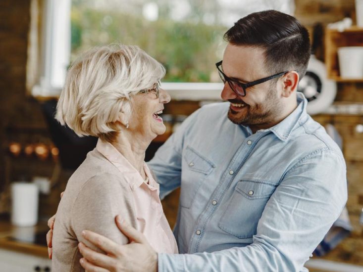 Old lady laughing while having a pleasant conversation with Home care guy
