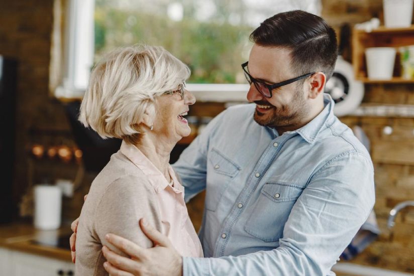 eqc-homecare-agency Old lady laughing while having a pleasant conversation with Home care guy