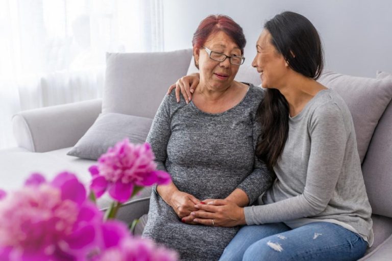 eqc-role-of-caregivers A young caregiver supporting an old lady to feel good