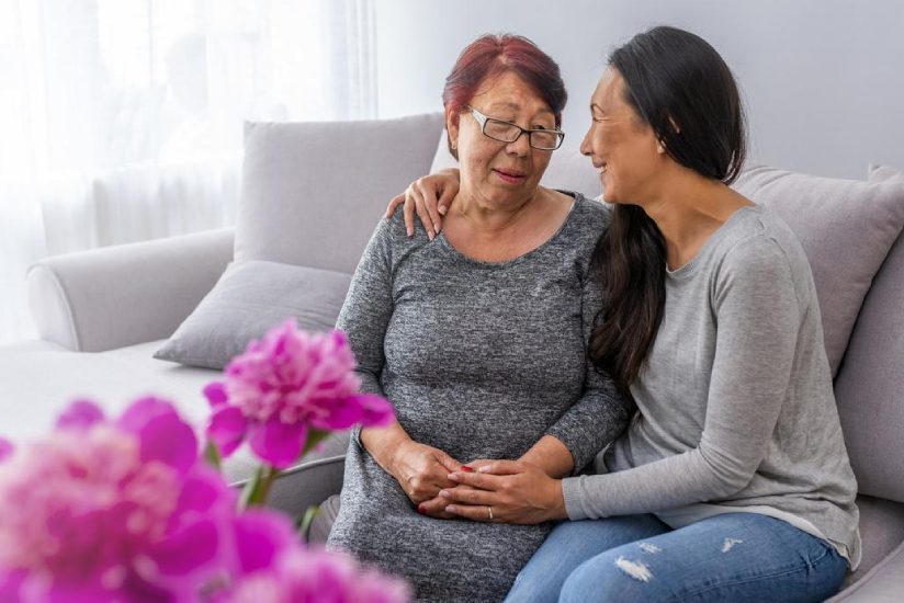 eqc-role-of-caregivers A young caregiver supporting an old lady to feel good