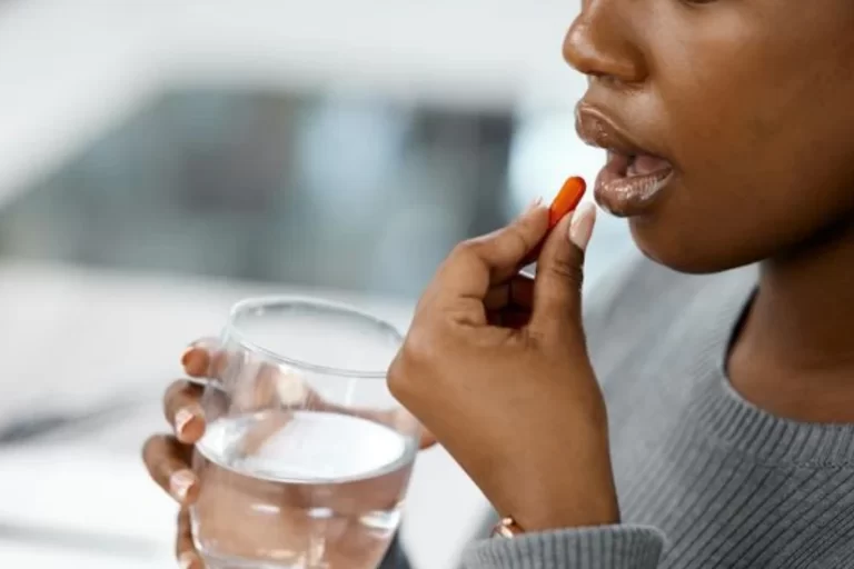 EQC Understanding Medication Therapy Management Young woman taking medicine