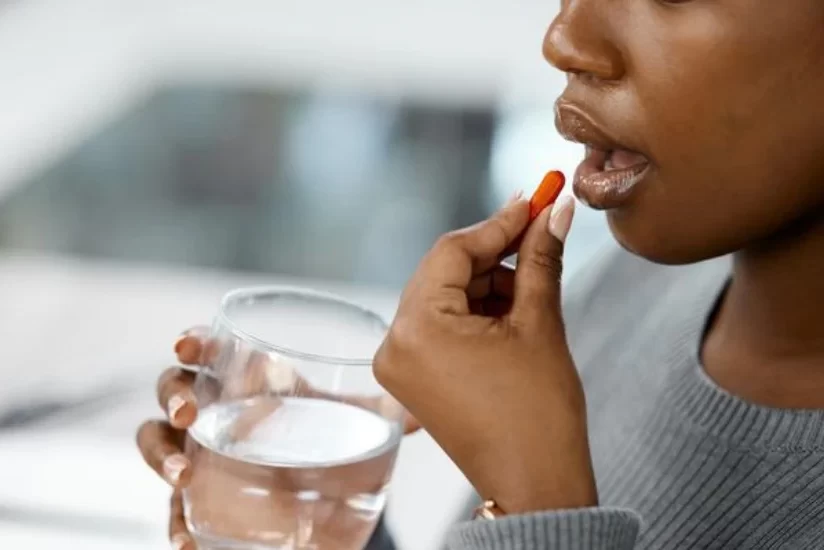 Young woman taking medicine