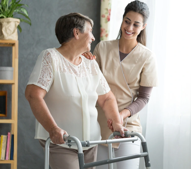 Caregiver helping old lady to walk