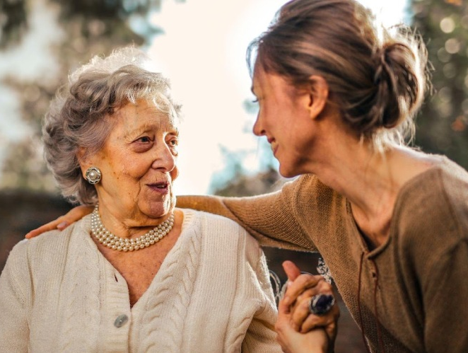 caregiver talking to an old lady