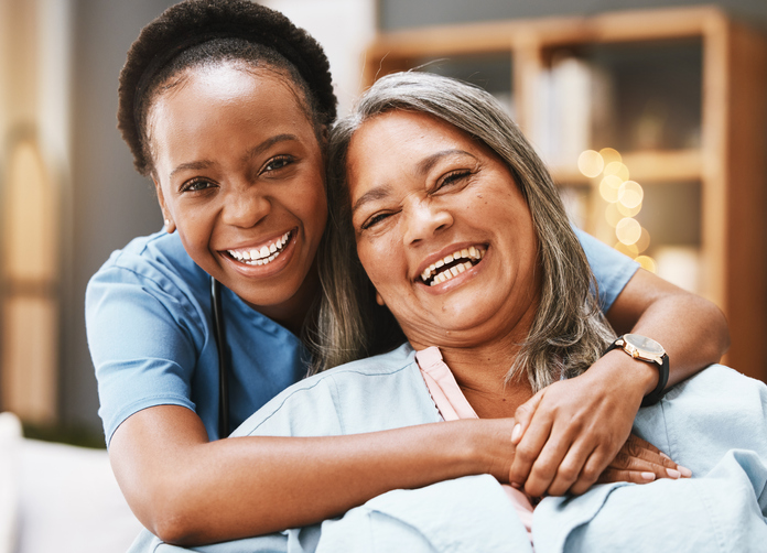 Senior care, hug and portrait of nurse with patient for medical help, healthcare or physiotherapy. Charity, volunteer caregiver and face of black woman at nursing home for disability rehabilitation