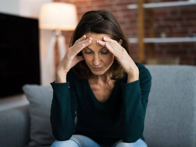 Stressed out woman sitting on a couch