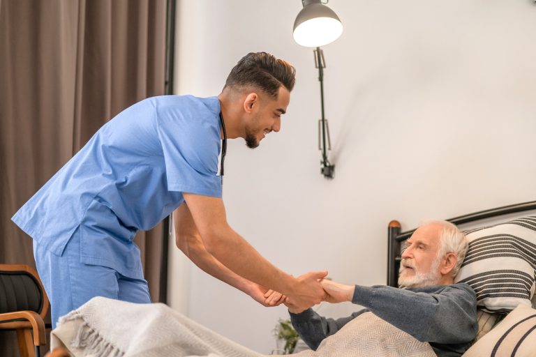 Male nurse taking care of an old man