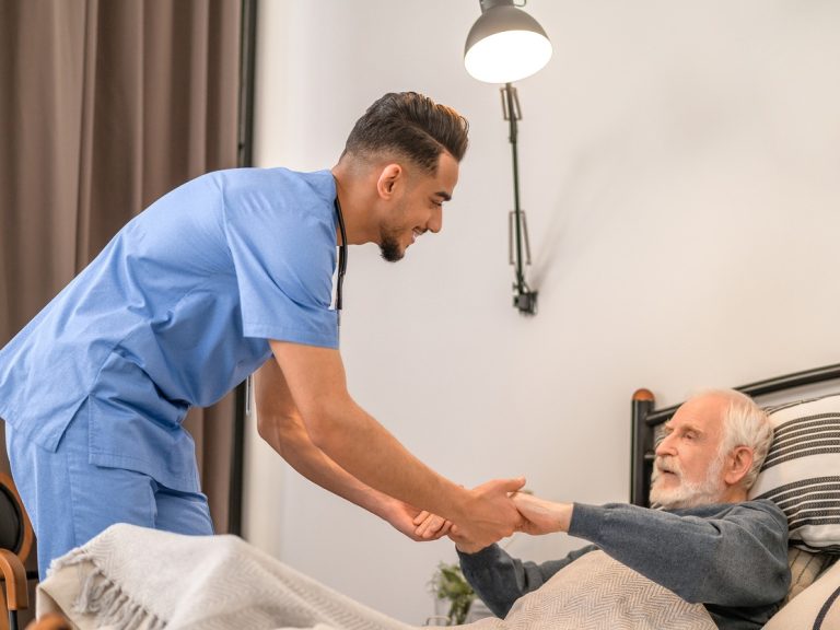 Male nurse taking care of an old man