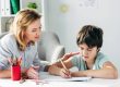 woman helping kid with homework