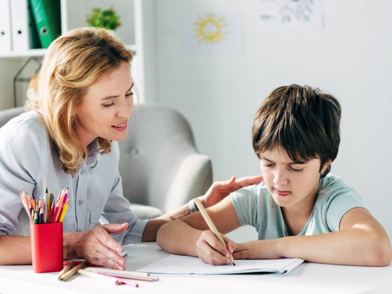 woman helping kid with homework