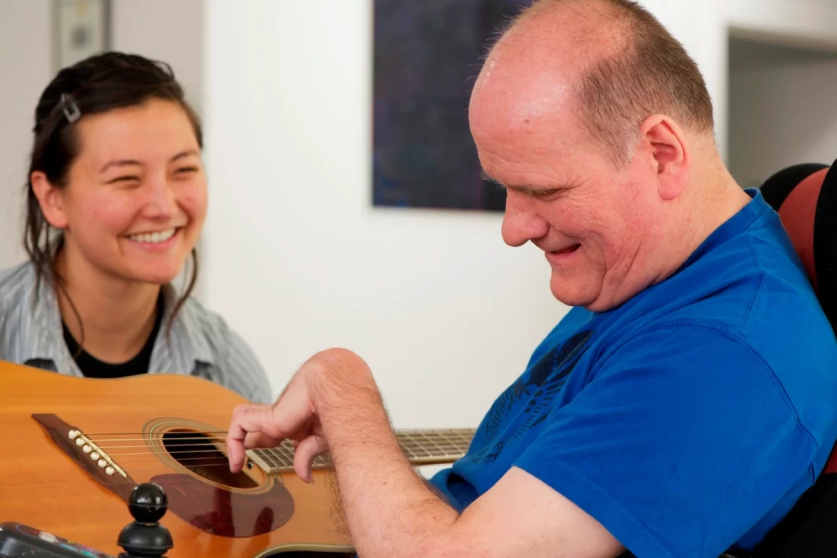 music01 special person playing guitar in care of home care lady