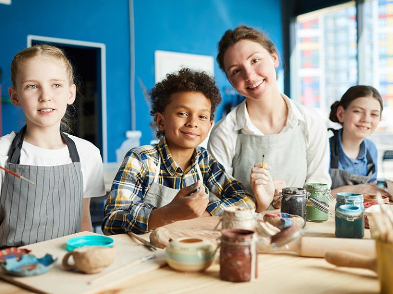 Kids doing painting with teacher