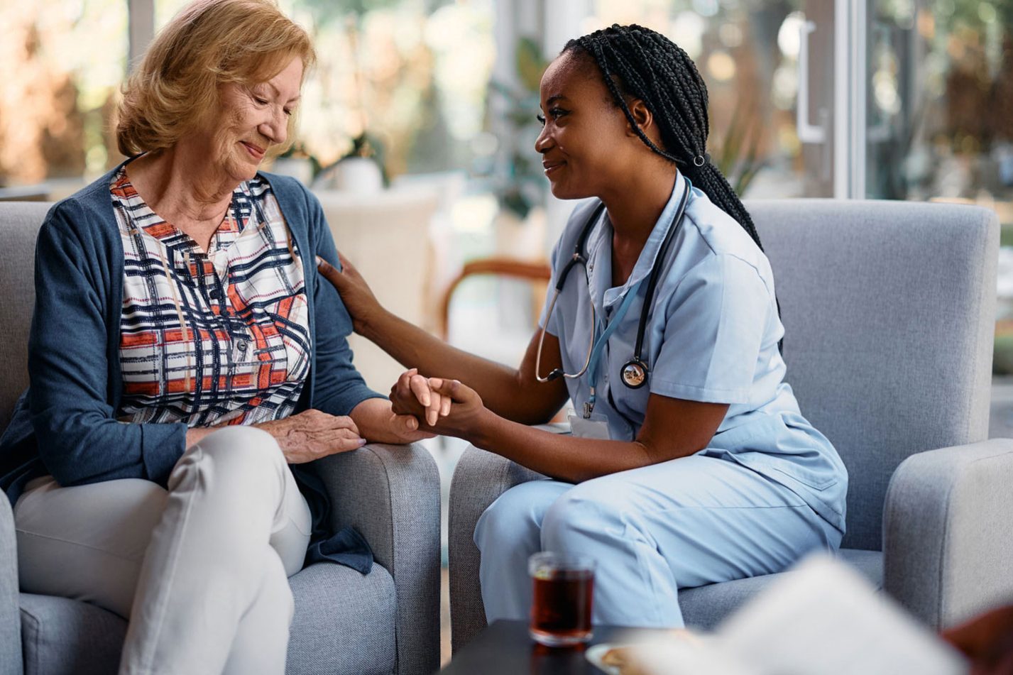 Nurse taking care of the aged woman