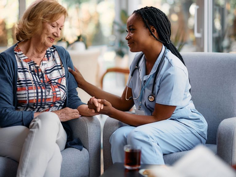 Nurse taking care of the aged woman