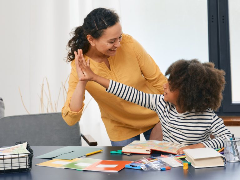 Teacher and kid doing high five