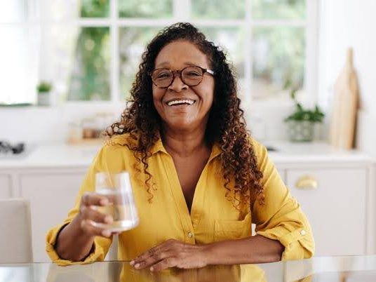 Woman holding a glass of water