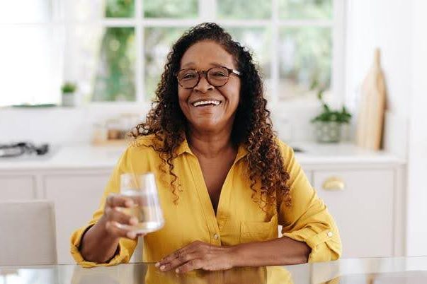 Hydration Myths and Facts Woman holding a glass of water